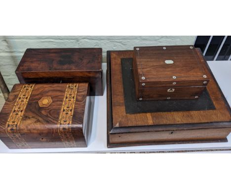 A group of four vintage boxes to include a mahogany tea caddy with mother of pearl inlay, a walnut tea caddy with marquetry i