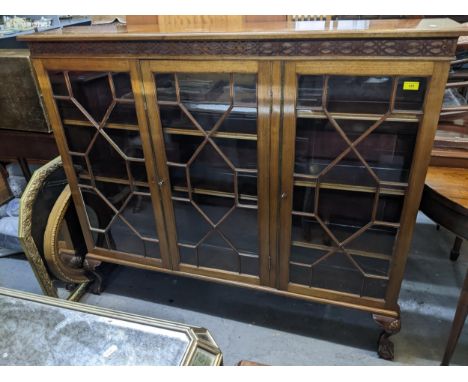 Edwardian mahogany triple-door display cabinet, label for Denby and Spinks of Leeds verso, overhanging top with moulded edge 