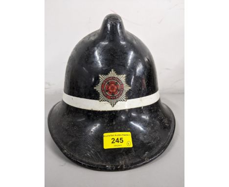 An early/mid 20th century Hampshire Fire Service fireman/firewomen helmet with leather lining and a chin strapLocation: 1-1If
