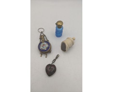 A group of Stanhopes to include a blue enamel scent bottle, along with one other scent bottle, a bone whistle and obsidian ge