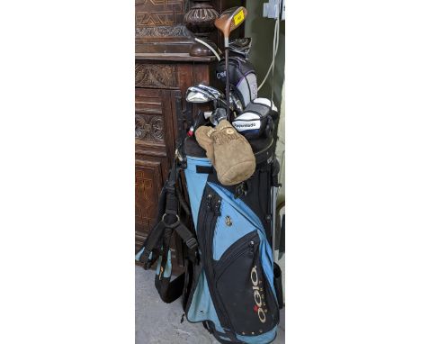 An Ogio golf club bag containing a mixed selection of golf club irons and woods to include Ping, Taylor Made, Burner and Hi R
