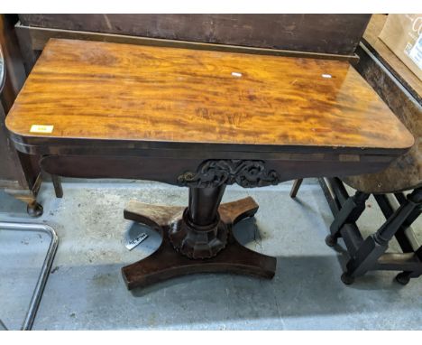 A Regency mahogany fold over card table with swivel top supported on a tapering column and quatrefoil base 71cm x 91cm x 44.5