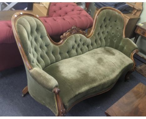 A Victorian walnut double spoon button back sofa with carved showood, framed and upholstered in green crushed velvetLocation:
