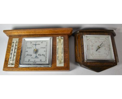 An Edwardian Oak Wall Hanging Weather Station, 32cm wide and a Similar Aneroid Barometer, 22cm wide 