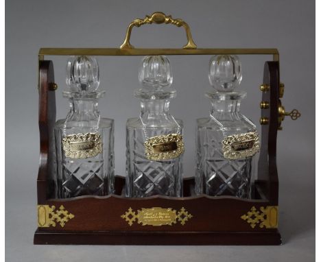 A Modern Brass Mounted Three Bottle Tantalus with Decanter Labels for Sherry, Gin and Whisky, Presentation Inscription, Compl