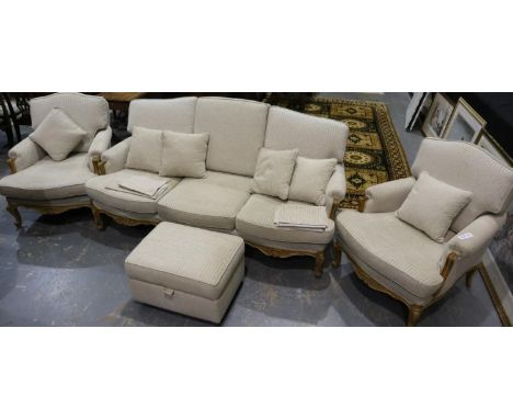 A 20th century three-piece lounge suite, walnut framed, comprising three-seat sofa and two armchairs, with footstool, largest