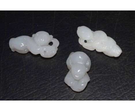 Group of three small white jade carved figures of boys, probably intended as netsuke (3)