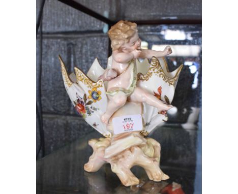 Continental posy vase, with a cherub mounted astride the vase, decorated with floral design (bow missing from cherub)   