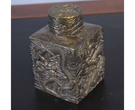 White metal caddy and cover of square section decorated with dragons in relief, the cover with similar decoration, 12cm high 