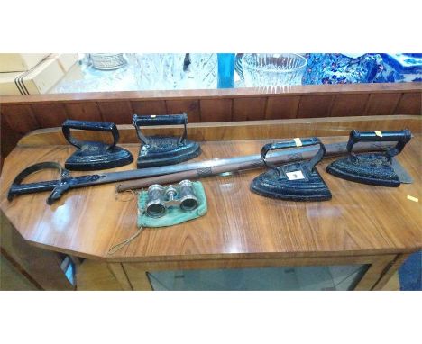 Four flat irons, an axe, opera glass etc.
