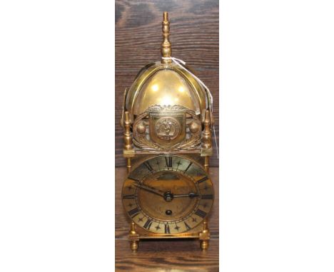 LATE 19TH CENTURY BRASS LANTERN CLOCK
with brass dial, Roman numerals, brass bell with shield decoration surrounding it, with