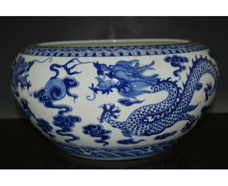 Chinese blue and white circular bowl, six character seal mark, decorated with dragons chasing flaming pearl, diameter 27cm.