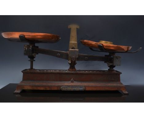 Set of French balance scales, labelled B Treyvou, with copper pans and three nesting brass weights, width overall, 49cm.