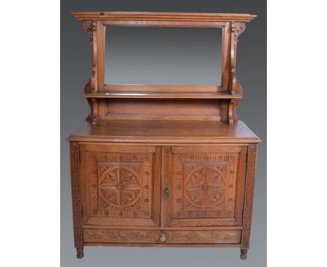 Oak sideboard, bevelled mirror panelled back, over an open shelf, the base with two carved panel doors over a single drawer, 