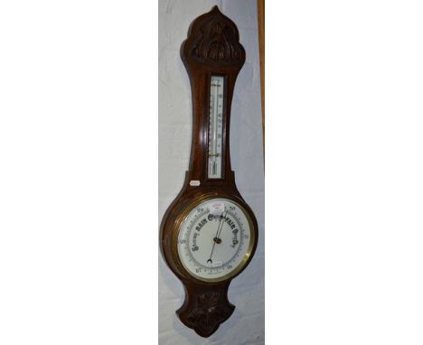 Carved oak aneroid wheel barometer, with a thermometer over, 86cm.