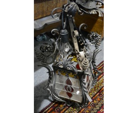 Wrought iron hall lantern, with scrolled terminals, leaded glazed panels, 70cm.