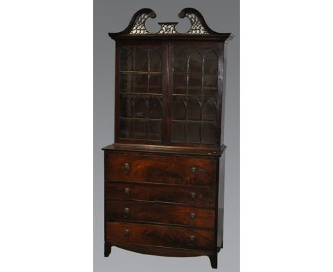 A George III mahogany bookcase secretaire, broken swan-neck pediment, with fretwork, two glazed panelled doors to the upper s