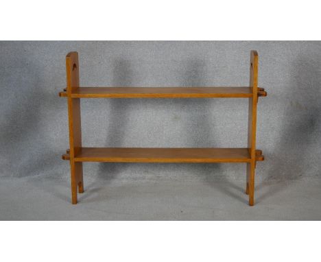 An Arts and Crafts light oak floor standing two tier open bookshelf. H.76.5 W.101.5 D.20.5cm 