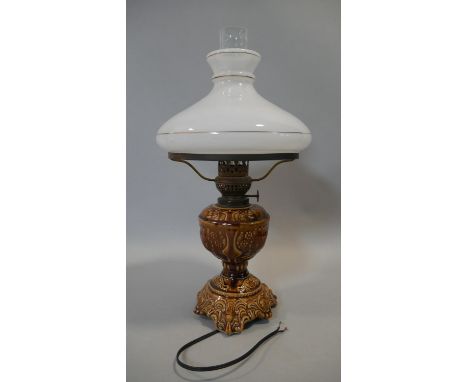 A table lamp with milk glass shade and ceramic base, converted from a 19th century oil lamp. H.52cm 