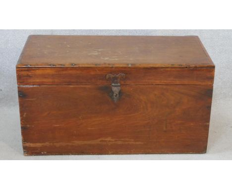 A 19th century camphor hinged lidded travelling trunk with twin iron carrying handles. H.40 W.77 D.37cm 