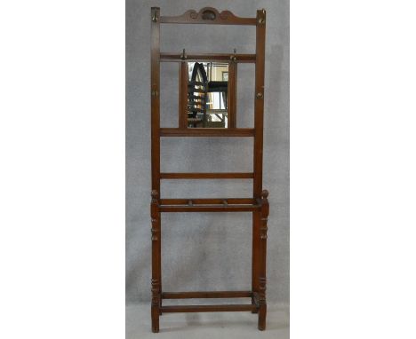 A late 19th century walnut mirror backed hallstand with three section umbrella and stick stand. H.192 W.69 D.27cm 