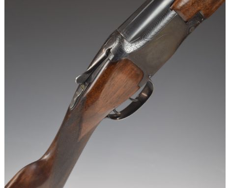 Browning 12 bore over and under ejector shotgun with engraved lock, trigger guard, underside, fences and thumb lever, chequer