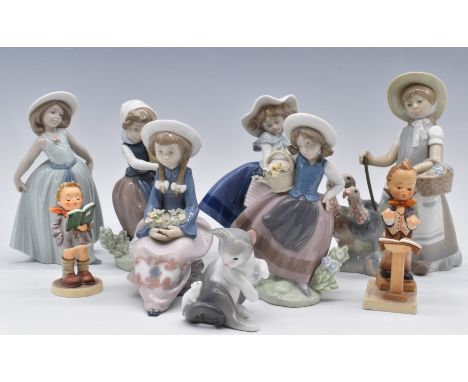 Six Lladro girl figurines, Lladro cat and two Goebel Hummels,&nbsp;tallest 22cm