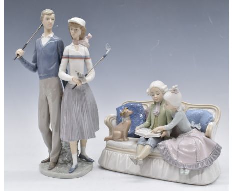 Two Lladro figural groups, one 'Ninos del Sofa' the other two golfers, both boxed, tallest 34cm