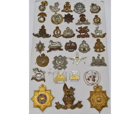 Collection of metal badges including Northumberland Fusiliers, Inniskilling Fusiliers, Inniskilling Dragoons, Lancashire Fusi