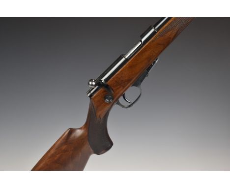 Walther .22 bolt-action rifle with chequered semi-pistol grip, sling mounts, adjustable sights, magazine and 22 inch barrel, 