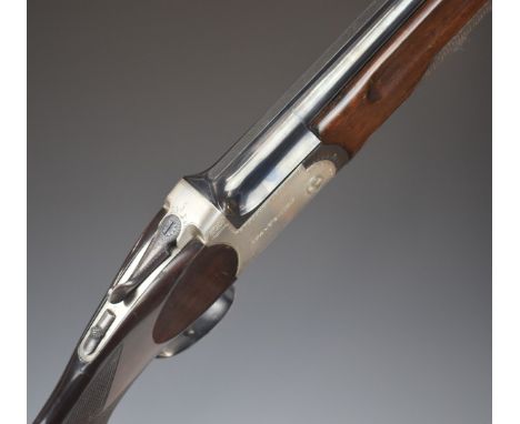 AYA Yeoman over under ejector shotgun with named and border engraved locks, chequered semi-pistol grip and forend, vented top