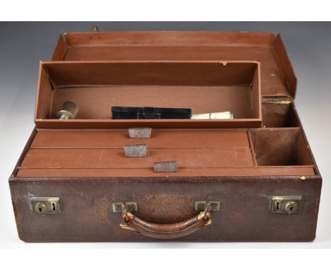 A leather surgeon's case with fitted interior of drawers, impressed with Professor R St Leger Brockman, together with a photo