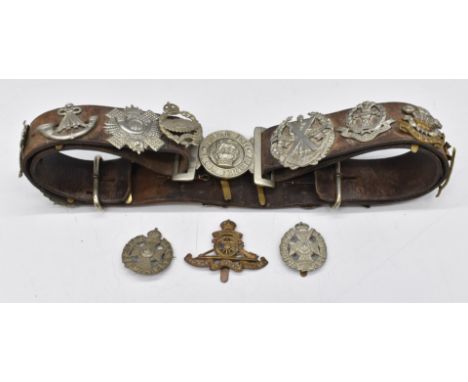 Eighteen cap badges including Rifle Brigade Royal Artillery, Highland Light Infantry, South Wales Borderers, Royal Marines, R