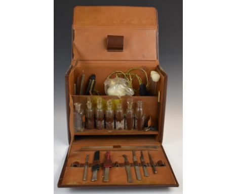 Vintage leather dentist's travelling case, the fitted interior including glass bottles and tools, some named Plucknett, width