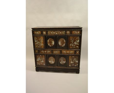 19th Century Chinese hardwood and mother of pearl inlaid side cabinet with a panelled frieze above an arrangement of sliding 