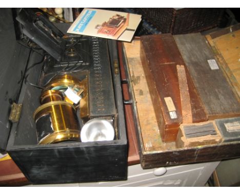 Black Japanned and brass magic lantern together with a pine box containing a quantity of various glass slides etc
