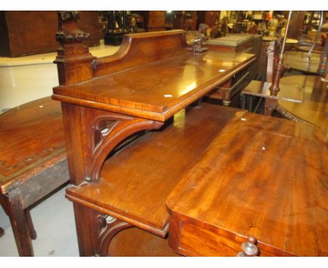 Victorian oak Gothic Revival three tier buffet, the crossbanded shelves with pierced and carved bracket supports raised on sh