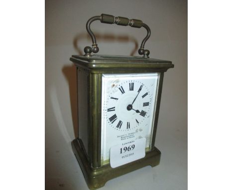 Early 20th Century gilt brass carriage clock, the enamel dial with Roman numerals, inscribed Brights Stores Ltd