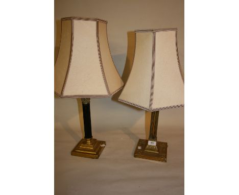 Two brass table lamps with shades, together with a brass and copper standard lamp