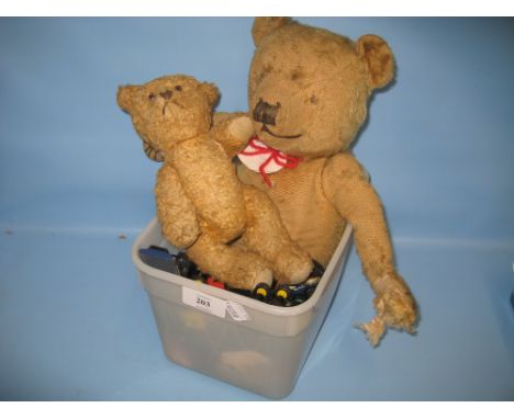 Two straw stuffed jointed teddy bears together with a small quantity of die-cast metal model vehicles