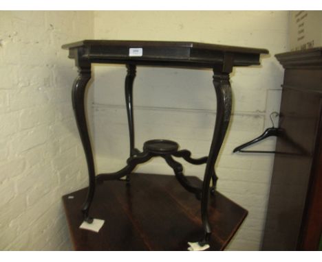 Edwardian octagonal walnut occasional table having slender carved cabriole supports with undertier, raised on ceramic and bra