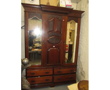 Late Victorian carved walnut wardrobe with a moulded cornice above centre panel flanked by two mirrored doors with drawers be