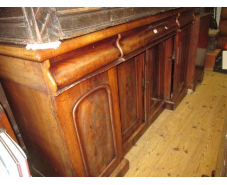 Victorian mahogany inverted breakfront sideboard with three drawers above four arched panel doors