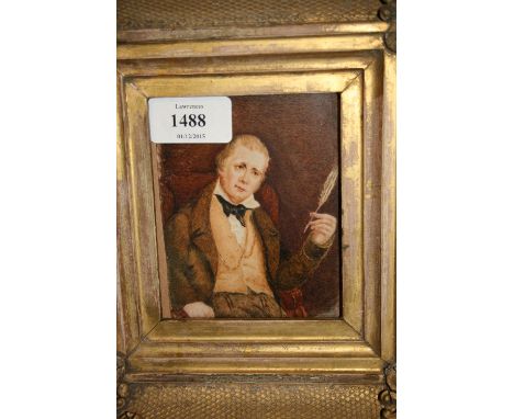 Heavy gilt framed miniature portrait on ivory, seated gentleman holding a quill pen