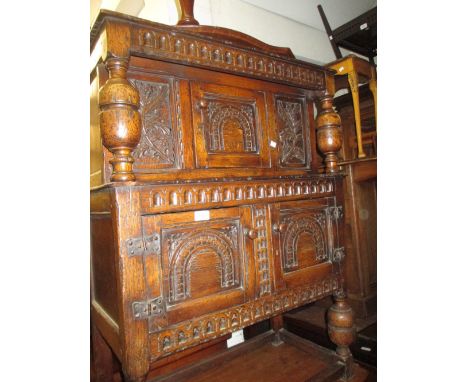 Small good quality reproduction carved oak court cupboard, the carved frieze above panel door with two further panel doors be