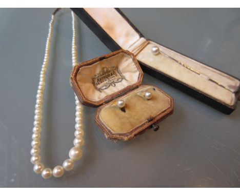 Small graduated cultured pearl necklace, cased pair of pearl ear studs and a pearl set stick pin