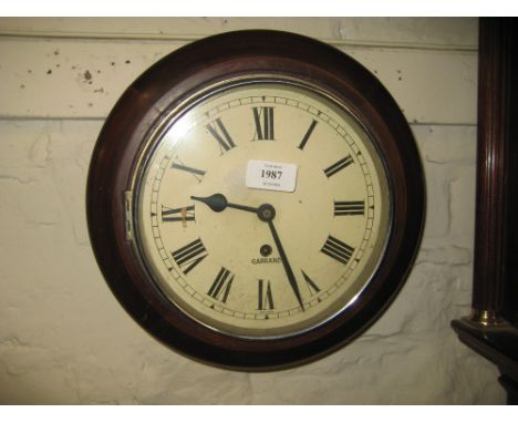 Small circular dial clock with cream dial and Roman numerals, with a single train movement signed Garrard