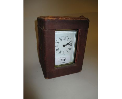 French gilt brass cased carriage clock having enamel dial with Roman numerals (crack to dial) in original simulated leather c