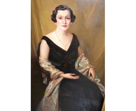 20th Century oil on canvas, a life size portrait of Lady Lavery, seated in an open armchair, bearing signature, 59ins x 39ins