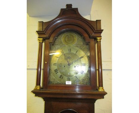 George III oak longcase clock, the broken arch hood above a crossbanded arched panel door and conforming plinth base, the bra